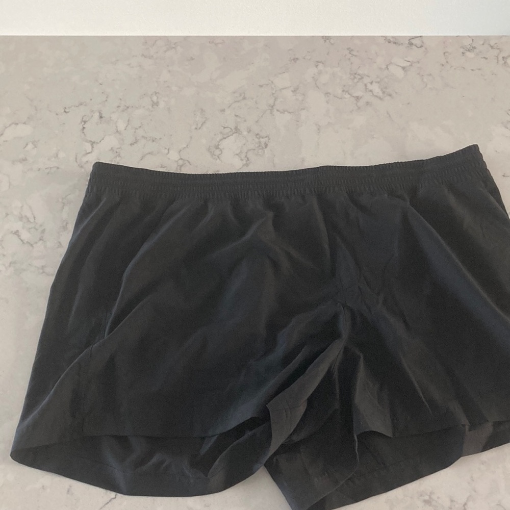 Black athletic shorts with 4 pockets and draw string. Worn once.